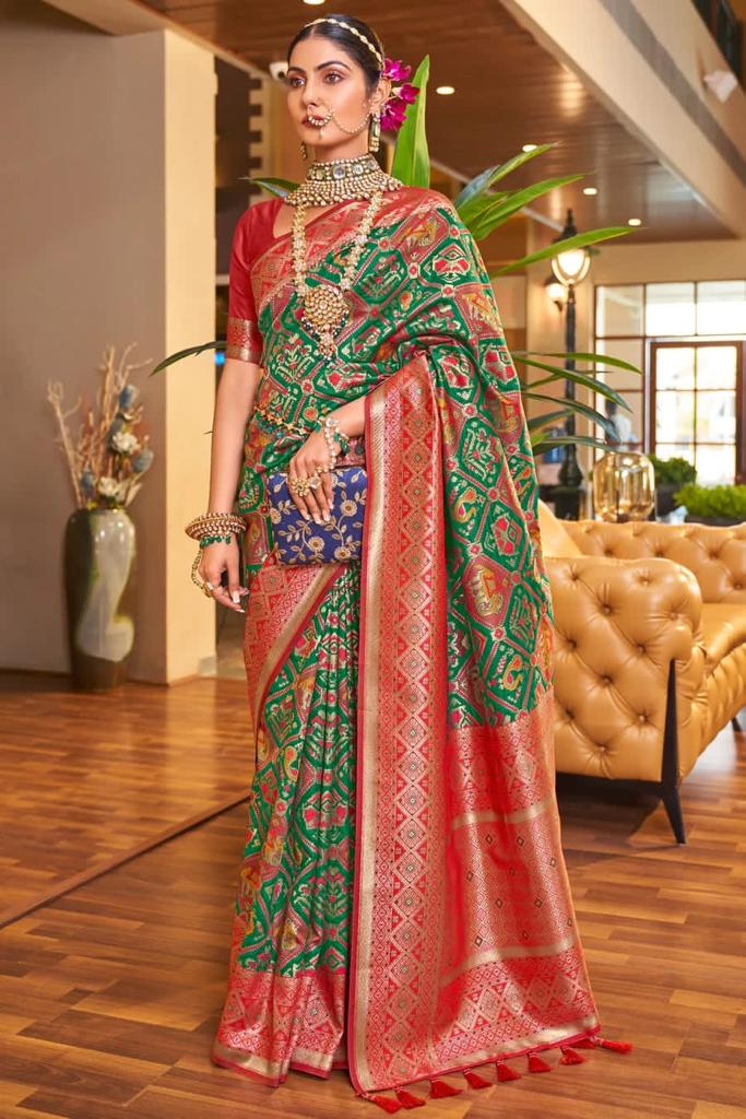 Alluring Dark Green Patola Silk Saree with Efflorescence Blouse Piece