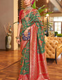 Alluring Dark Green Patola Silk Saree with Efflorescence Blouse Piece