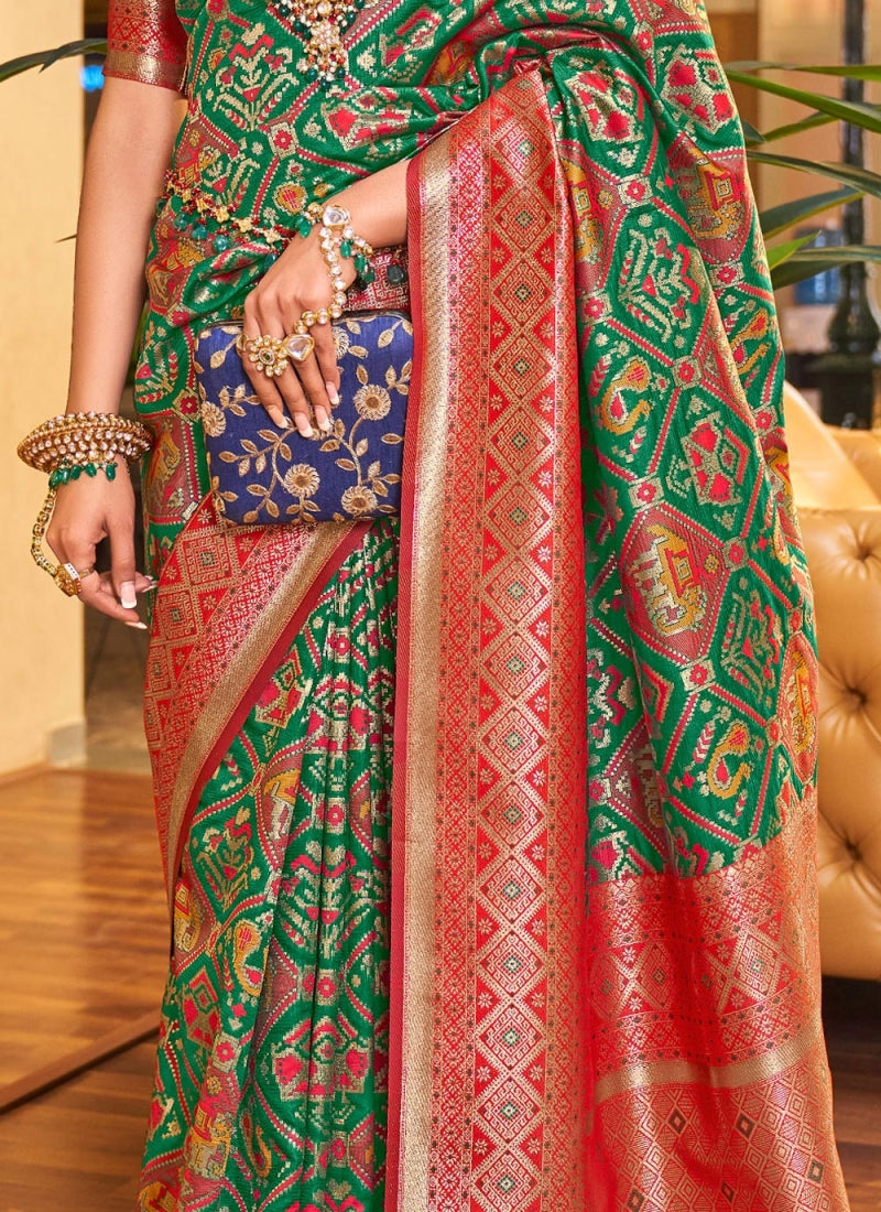 Alluring Dark Green Patola Silk Saree with Efflorescence Blouse Piece