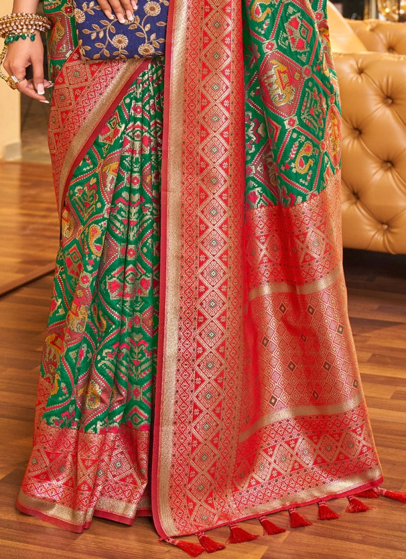 Alluring Dark Green Patola Silk Saree with Efflorescence Blouse Piece