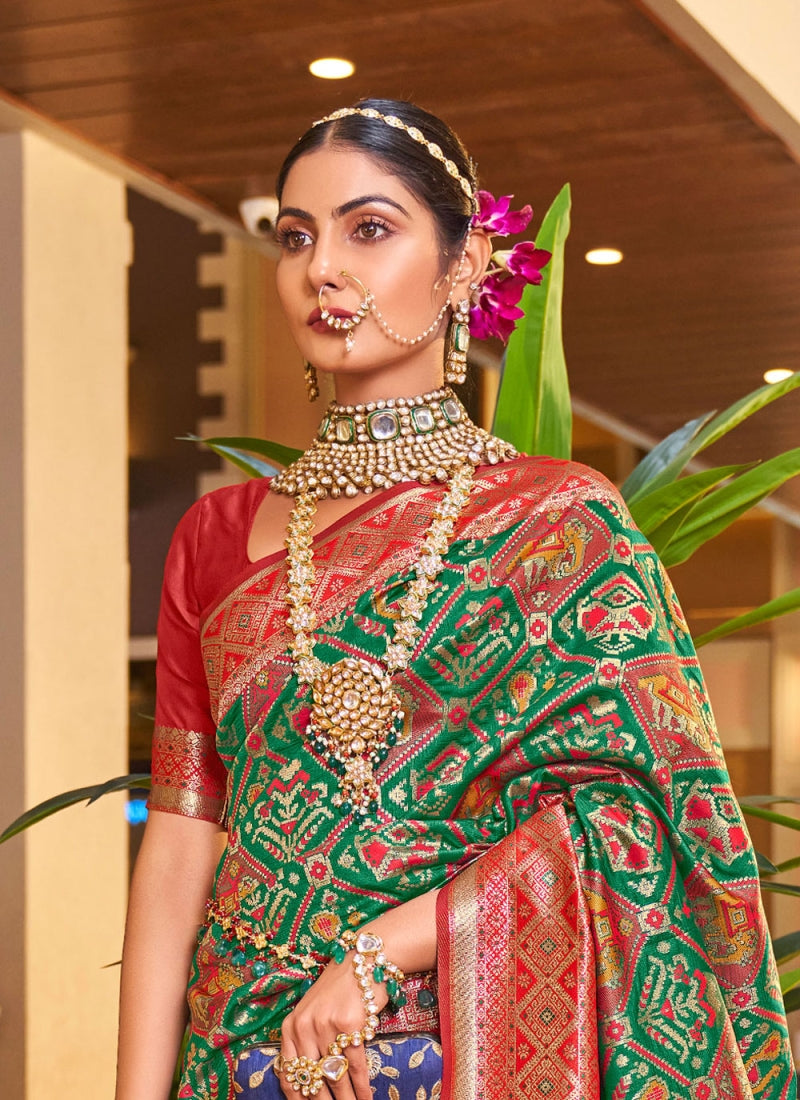 Alluring Dark Green Patola Silk Saree with Efflorescence Blouse Piece