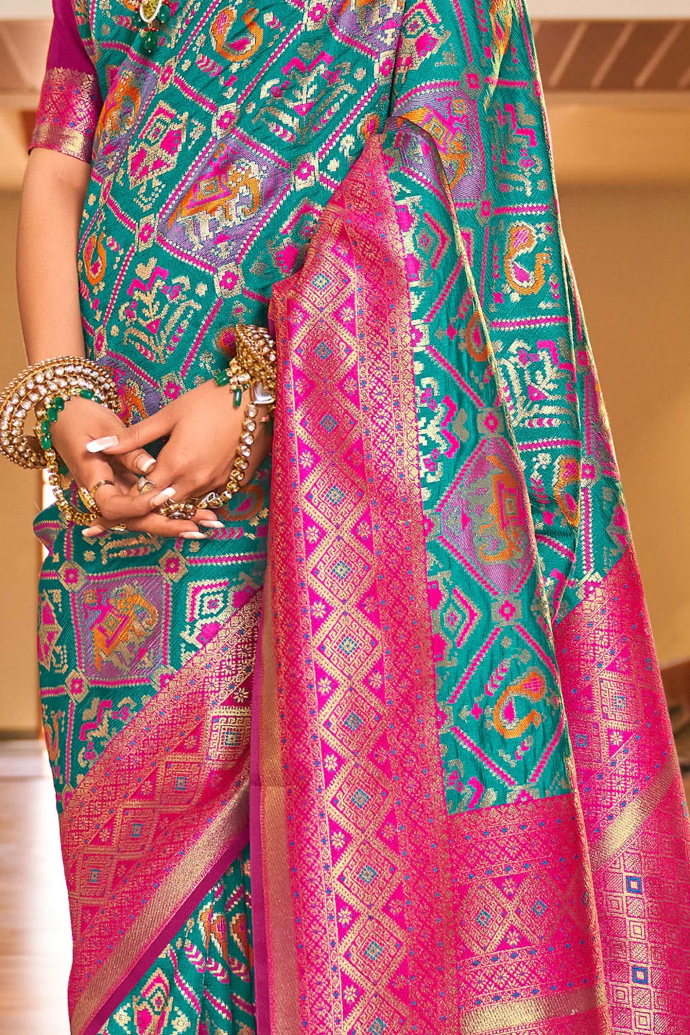 Sensational Turquoise Patola Silk Saree with Felicitous Blouse Piece