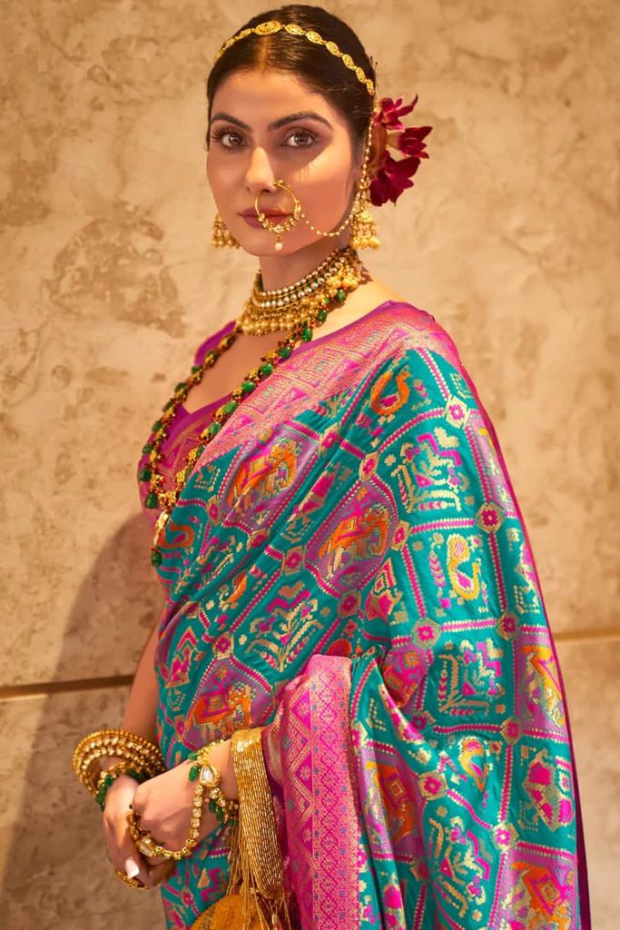 Sensational Turquoise Patola Silk Saree with Felicitous Blouse Piece