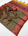 Sonorous Green Printed Patola Handloom Silk Saree With Adoring Blouse Piece
