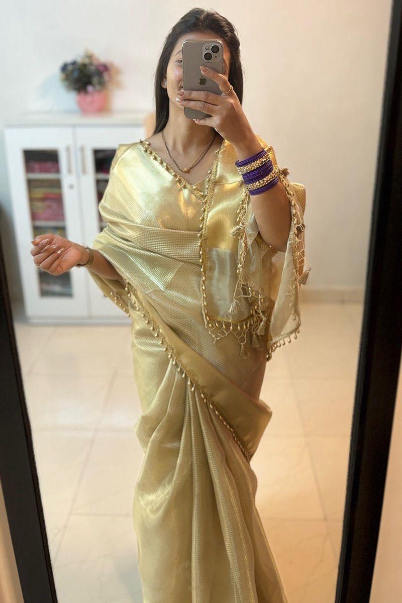 Dazzling Golden Soft Tissue Silk Saree With Zephyr Blouse Piece