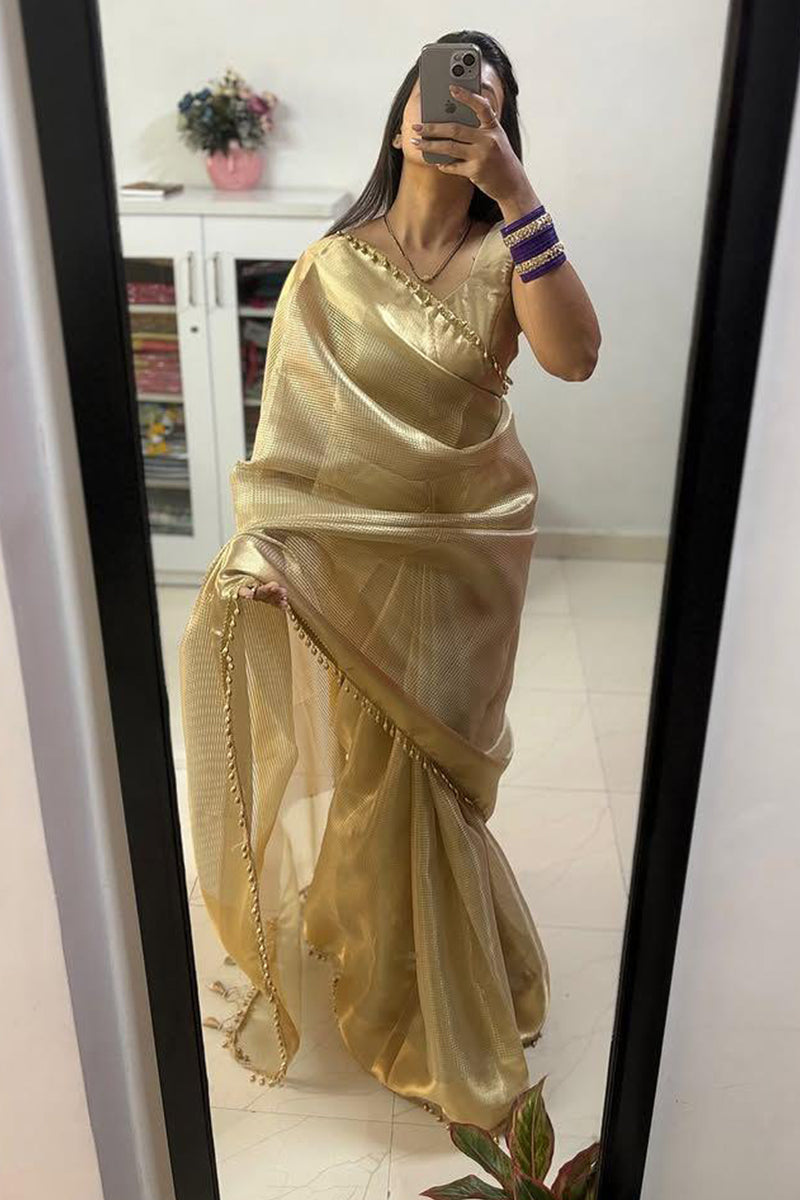 Dazzling Golden Soft Tissue Silk Saree With Zephyr Blouse Piece