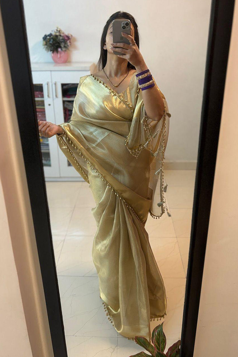 Dazzling Golden Soft Tissue Silk Saree With Zephyr Blouse Piece