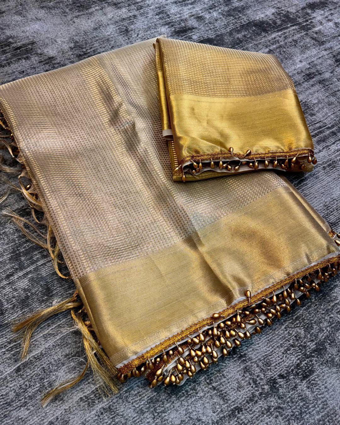 Dazzling Golden Soft Tissue Silk Saree With Zephyr Blouse Piece