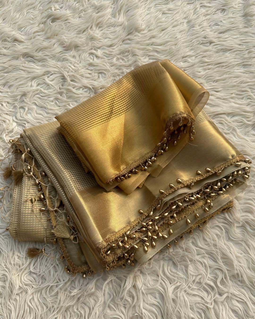 Dazzling Golden Soft Tissue Silk Saree With Zephyr Blouse Piece